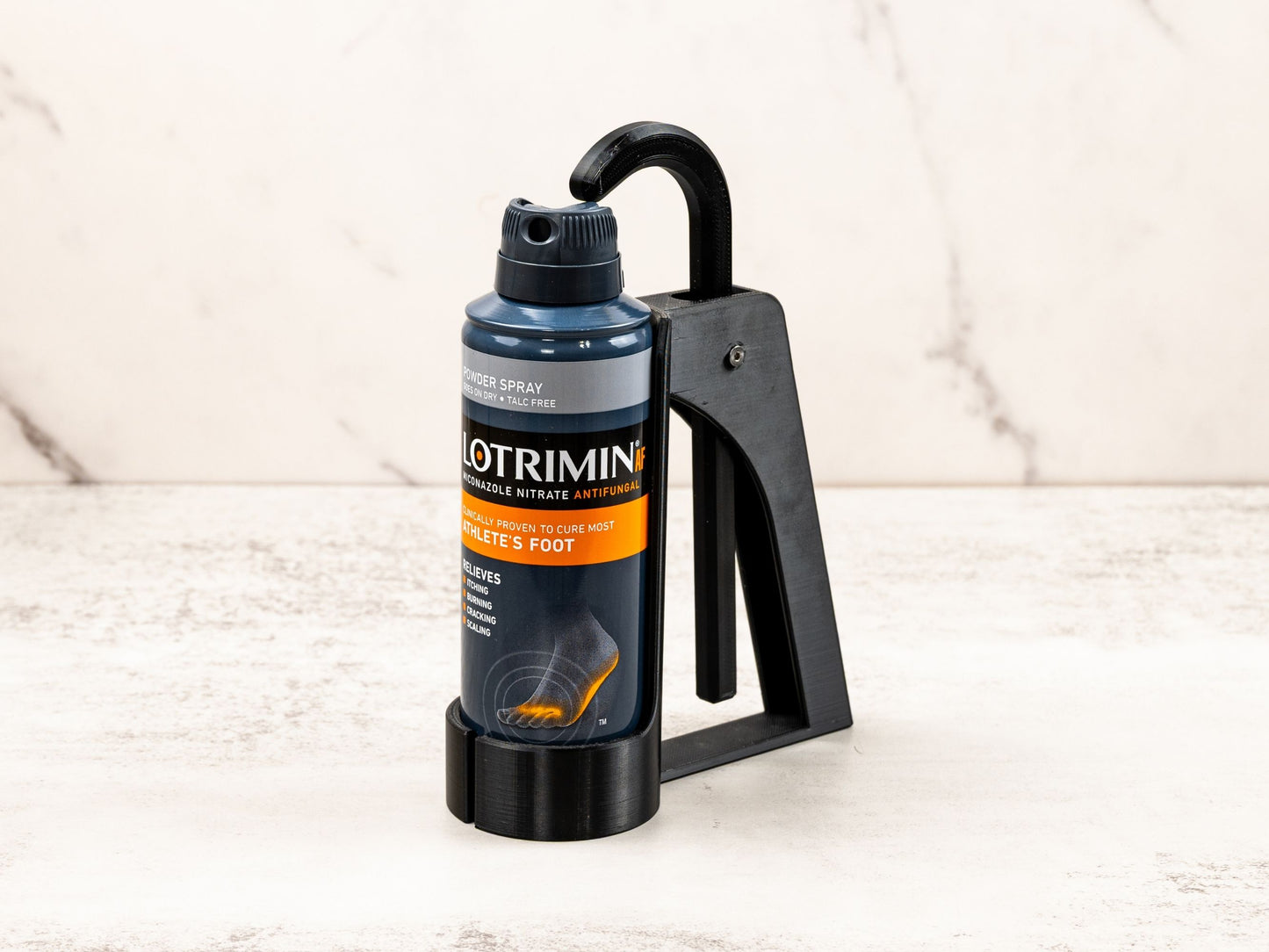 Foot Spray Assistant securely holding a Lotrimin can, shown at a slight angle for a clear view of the device in use.