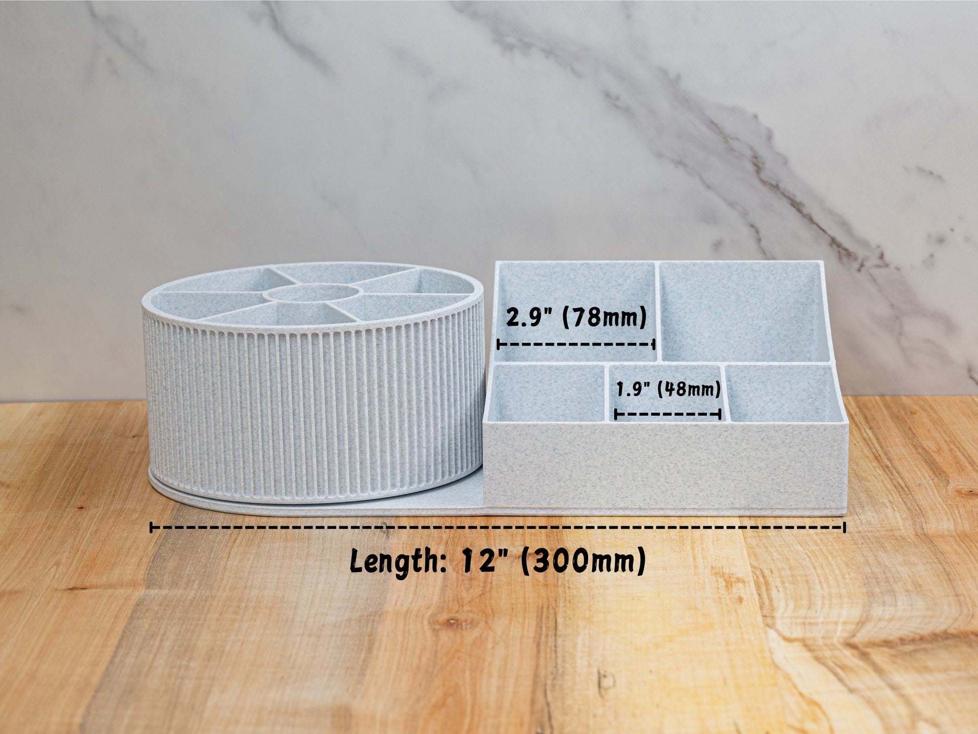 Front measurement graphic of the rotating beauty organizer on a wood surface: overall length labeled 12 in (300 mm). Base compartments annotated with interior widths of 2.9 in (78 mm) for the larger sections and 1.9 in (48 mm) for the smaller sections.