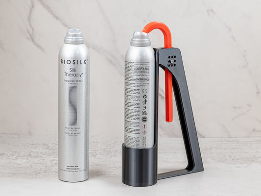 BioSilk hairspray can displayed beside the adaptive Hairspray Assistant designed for tall spray cans.