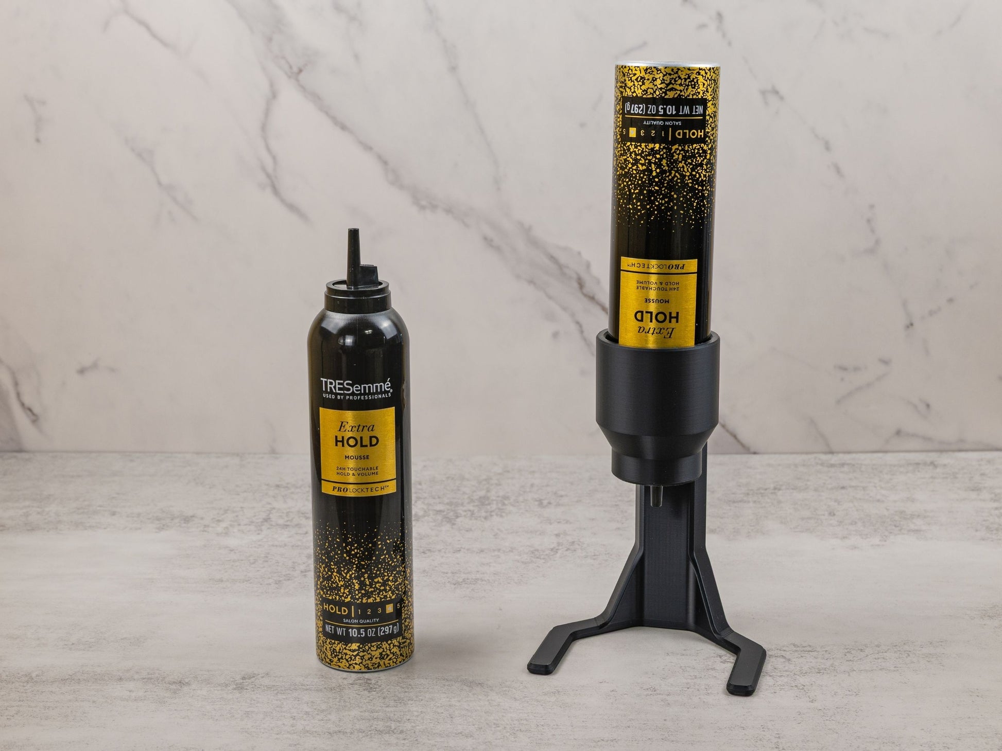 Visual comparison of a TRESemmé mousse can next to the mousse can mounted in the black PLA plastic dispenser for accessibility.