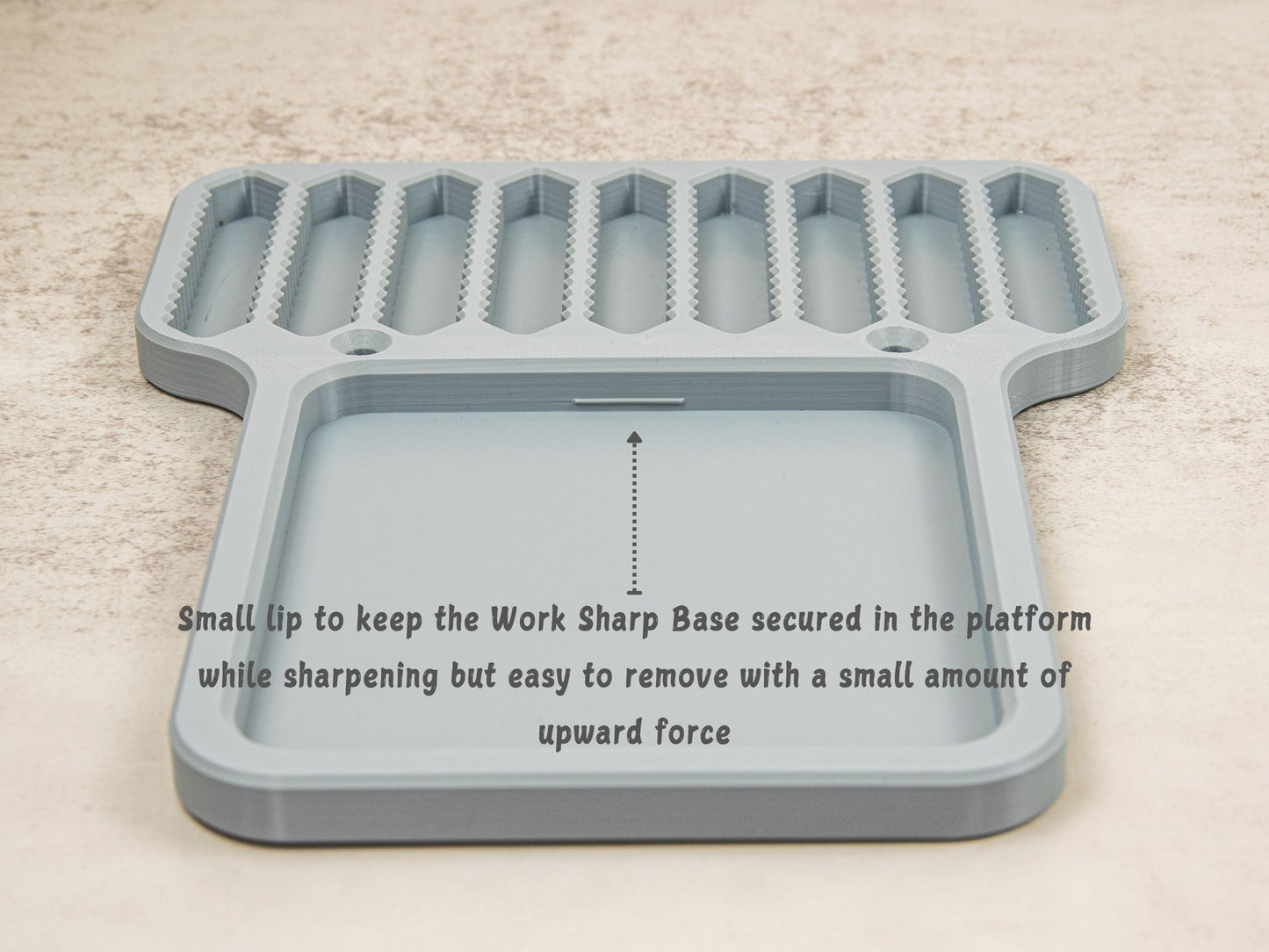 Back view of platform base with lip securing the Work Sharp Precision Adjust sharpener during use.