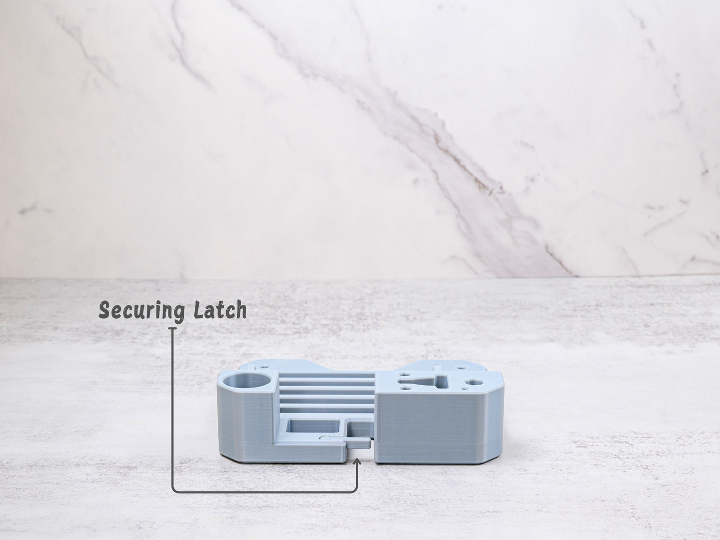 Rear view of the organizer tray mounted on the Xarilk Gen 3 Knife Sharpener showing the built in securing latch that locks the tray in place.