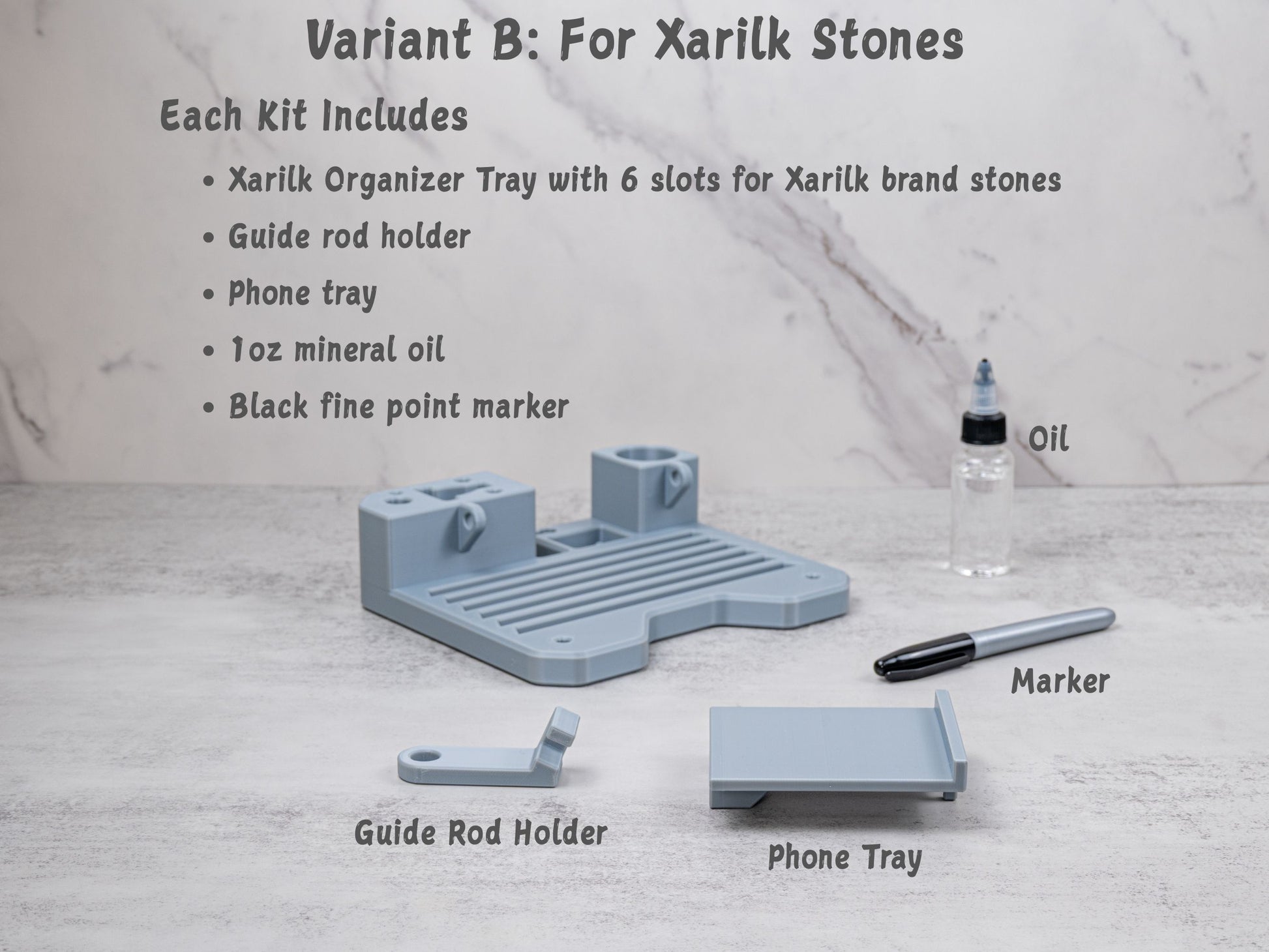 Variant B organizer tray kit for the Xarilk Gen 3 Knife Sharpener displayed on a tabletop, including the tray with six slots for Xarilk brand stones, guide rod holder, phone tray, mineral oil, and black fine point marker.