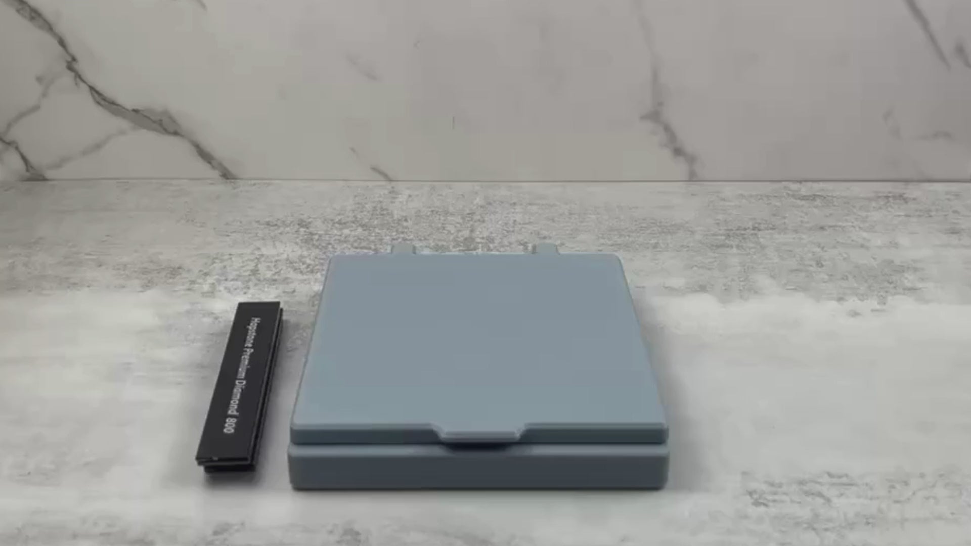 Demonstration of the sharpening stone storage case with lid, showing how 6"x1" stones fit securely inside and how the magnetic lid and reinforced hinges operate.
