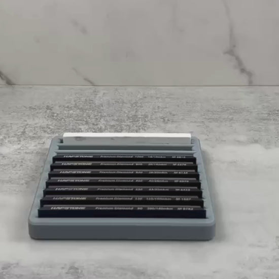 Demonstration video of a sharpening stone tray organizing multiple 6"x1" diamond stones, showing secure fit and easy stone access.