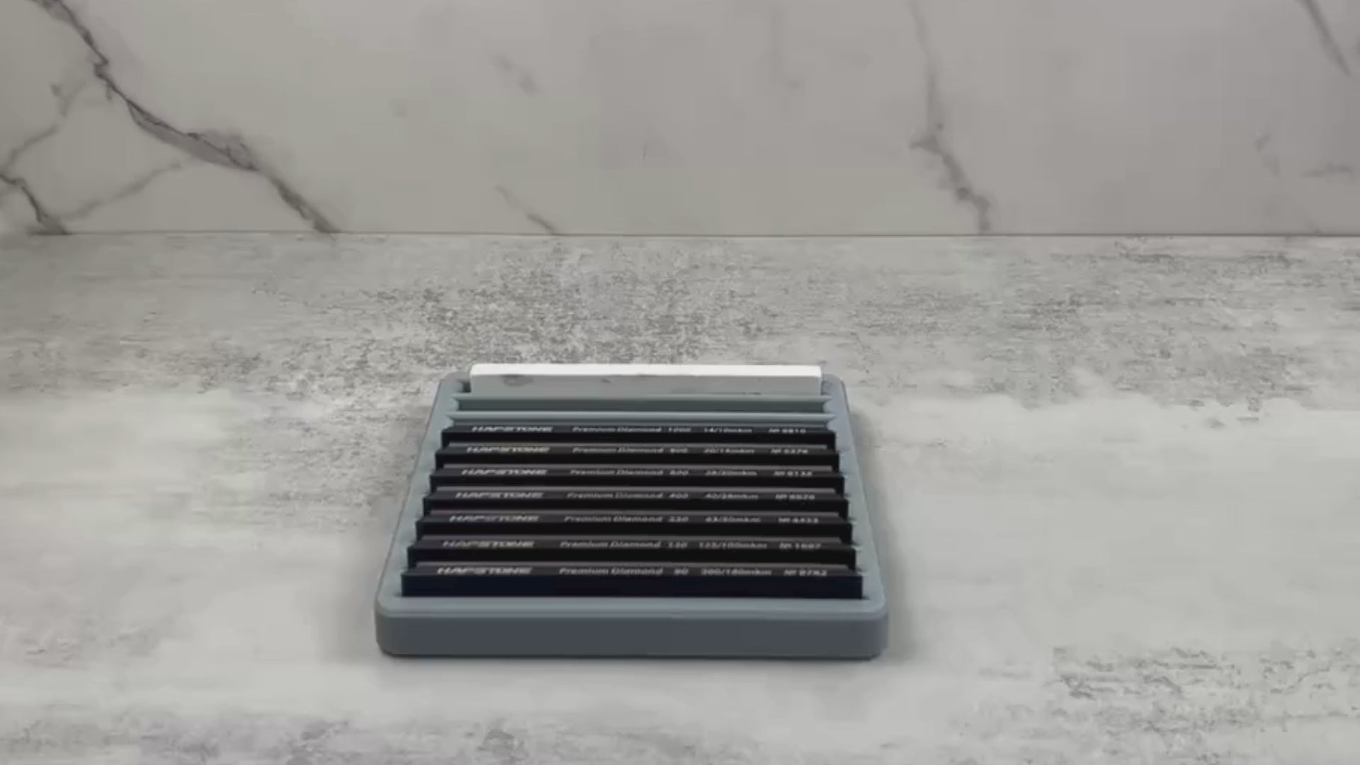 Demonstration video of a sharpening stone tray organizing multiple 6"x1" diamond stones, showing secure fit and easy stone access.