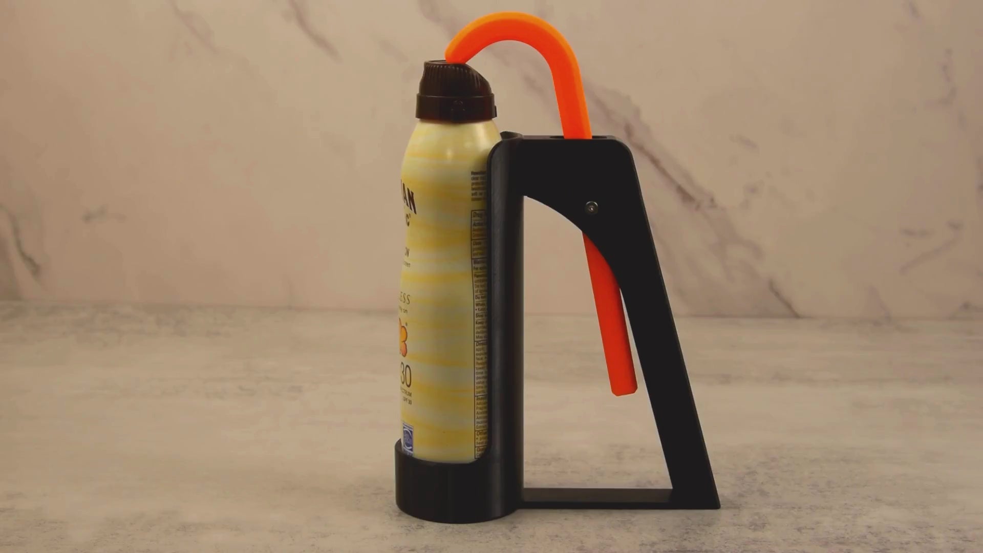 Video showcasing the Sunscreen Spray Assistant making it easier to apply spray sunscreen using one hand, ideal for users with hand strength limitations.